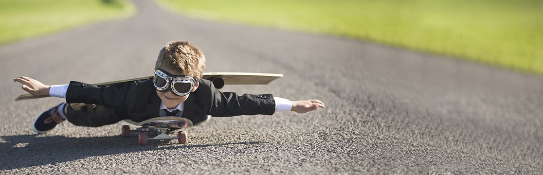 Child laying down on skateboard